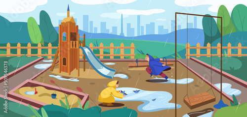 Flat kids playground at rainy weather with puddles and sandbox, slide, swings. Boys child in yellow rain boots and raincoat running and playing at park. Public kid area with sandpit, seesaw and slider