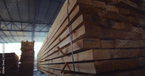 The loader brings wood in a pallet. Loading business timber in a warehouse. Woodworking industry. High quality 4k footage