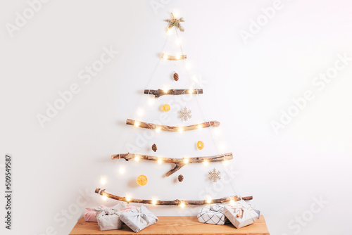 Furoshiki gift boxes near zero waste Christmas tree at home.