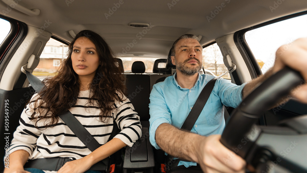 Serious Couple Driving Sitting In Automobile Enjoying Trip, Panorama Serious Couple Driving Sitting In Automobile Enjoying Trip, Panorama