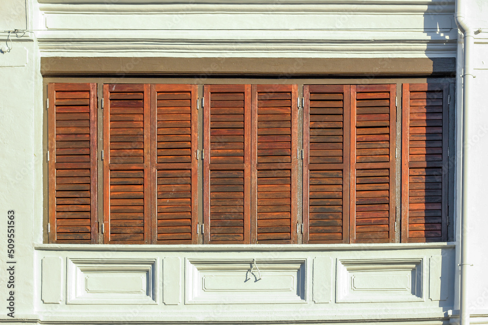 Detail of rectangular wooden windows of an old vintage shop house in the heritage town of Penang.