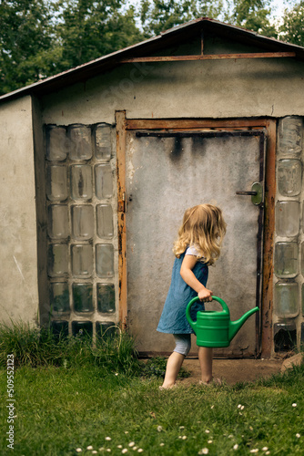 Little blonde girl gardening