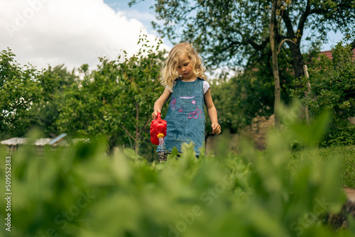 Little blonde girl gardening