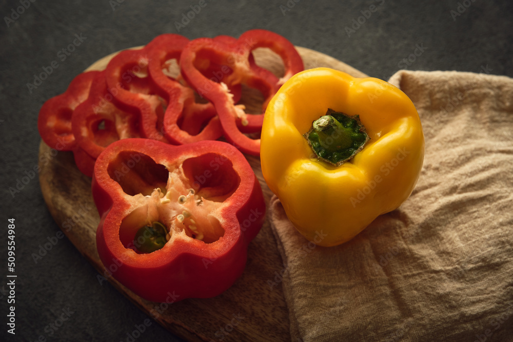 yellow and red peppers on the cutting board yellow and red peppers on the cutting board