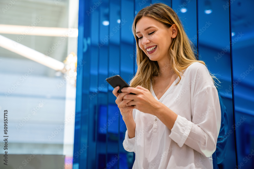 Fototapeta premium Portrait of happy beautiful smiling business woman using mobile phone. Technology people concept