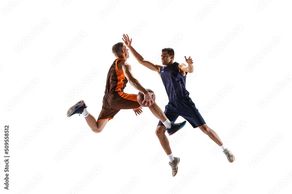 Dynamic portrait of two basketball playera in motion, in a jump, throwing ball into basket isolated over white studio background Dynamic portrait of two basketball playera in motion, in a jump, throwing ball into basket isolated over white studio background