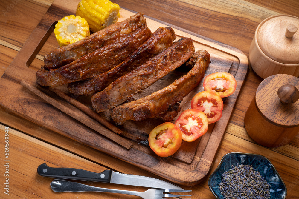Pork Spare Ribs with Barbecue seasoned spicy basting sauce, Grilled sliced barbecue pork ribs on wooden plate. Pork Spare Ribs with Barbecue seasoned spicy basting sauce, Grilled sliced barbecue pork ribs on wooden plate.