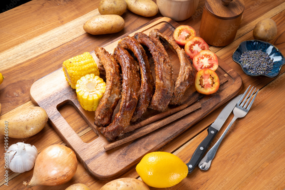 Pork Spare Ribs with Barbecue seasoned spicy basting sauce, Grilled sliced barbecue pork ribs on wooden plate. Pork Spare Ribs with Barbecue seasoned spicy basting sauce, Grilled sliced barbecue pork ribs on wooden plate.