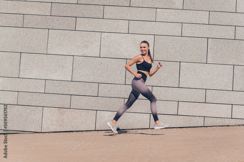 Fototapeta premium Profile side photo of sportive coach lady energetic coach look building friends run slowly outdoors