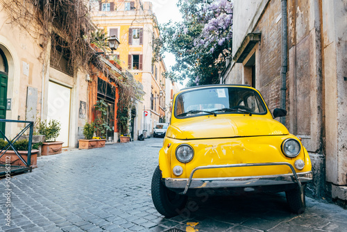 a classic fiat 500 vehicle is parked in roman street photo