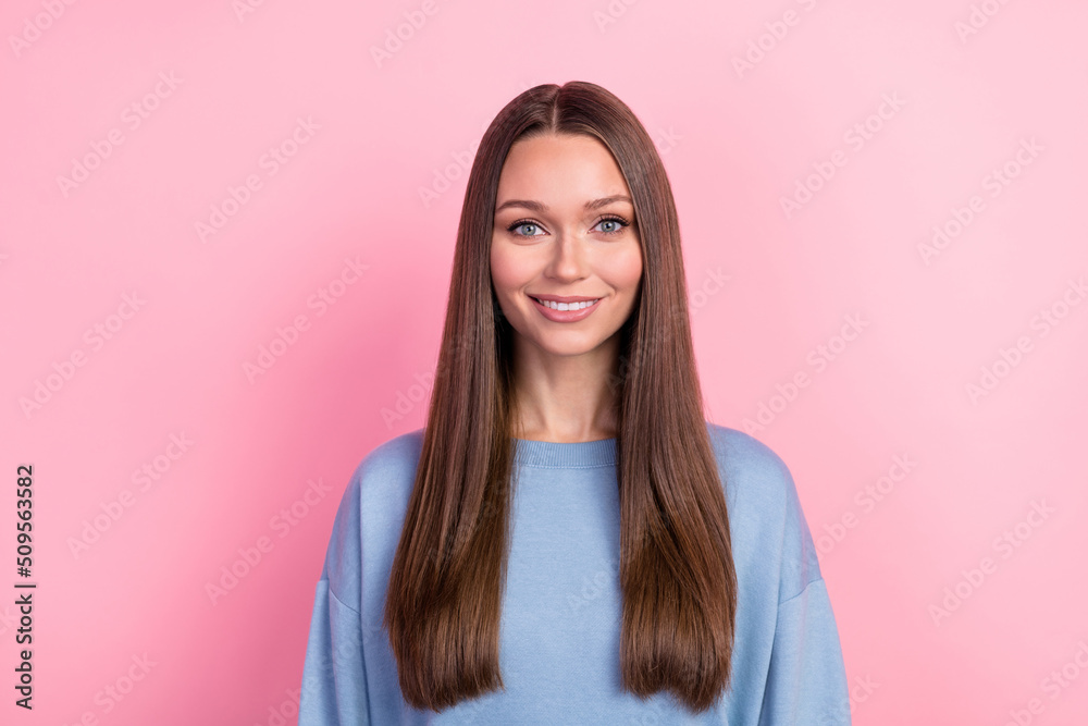 Portrait of attractive cheerful brunet girl wearing cozy jumper isolated over pink pastel color background
