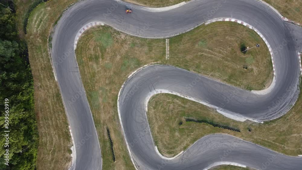 A stunning aerial view of a go kart track while a driver races.