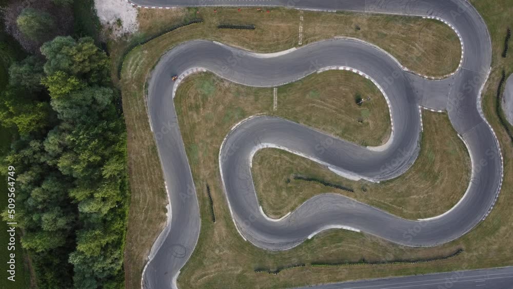 A stunning aerial view of a go kart track while a driver races.