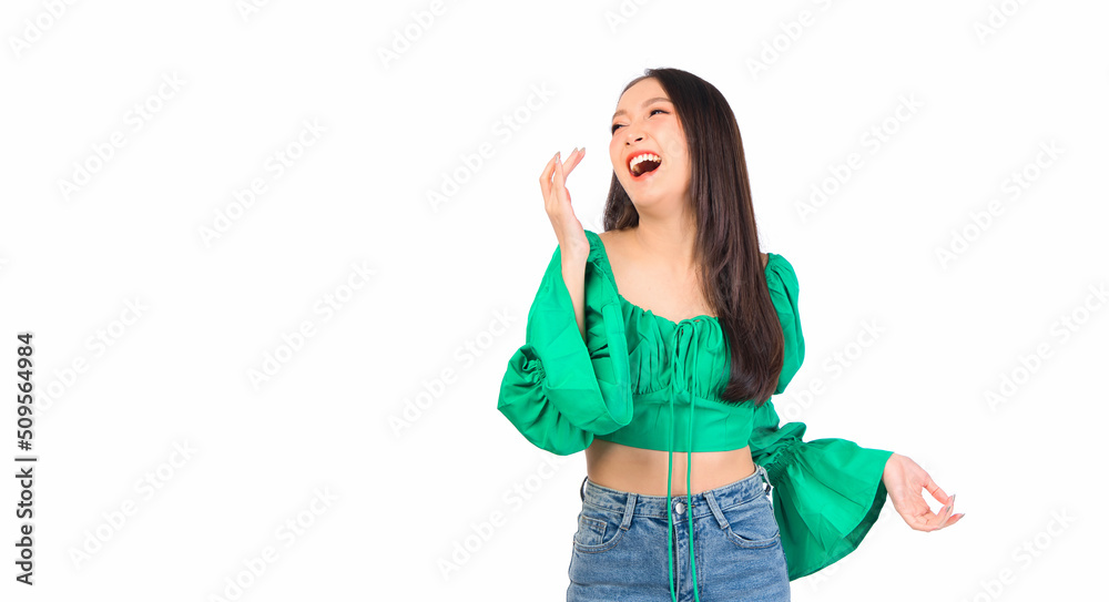 Attractive beautiful positive happy smile asian woman hands point up and pose with empty space wearing green shirt and jeans. Attractive beautiful positive happy smile asian woman hands point up and pose with empty space wearing green shirt and jeans.