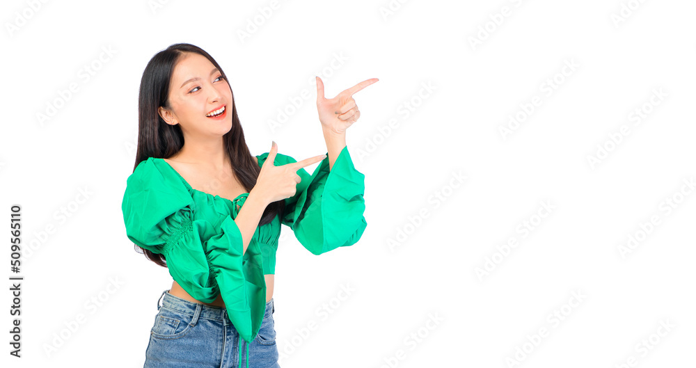 Attractive beautiful positive happy smile asian woman hands point up and pose with empty space wearing green shirt and jeans. Attractive beautiful positive happy smile asian woman hands point up and pose with empty space wearing green shirt and jeans.
