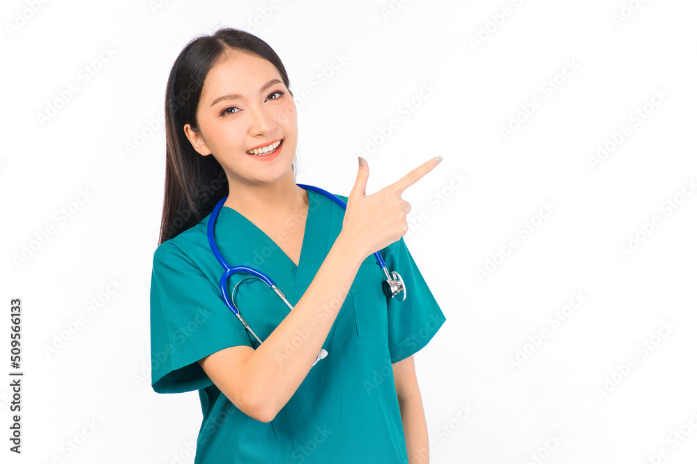 Portrait of professional confident young asian female smiling doctor in green scrubs showing presenting finger to empty space, doctor healthcare and doctors concept. Portrait of professional confident young asian female smiling doctor in green scrubs showing presenting finger to empty space, doctor healthcare and doctors concept.