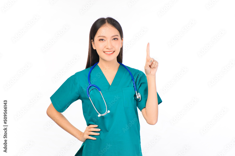 Portrait of professional confident young asian female smiling doctor in green scrubs showing presenting finger to empty space, doctor healthcare and doctors concept. Portrait of professional confident young asian female smiling doctor in green scrubs showing presenting finger to empty space, doctor healthcare and doctors concept.