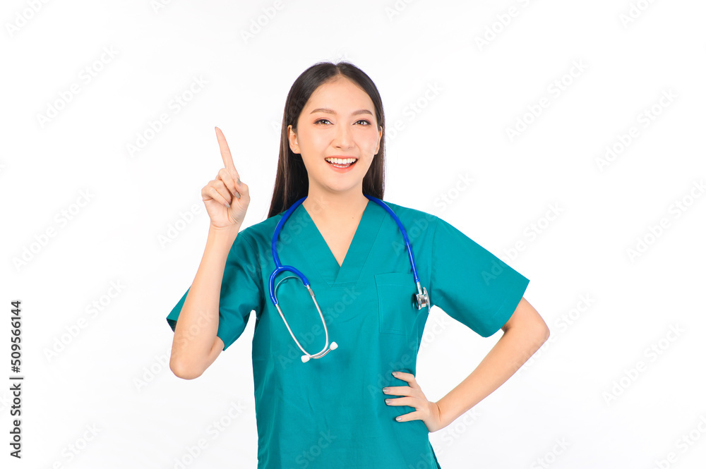 Portrait of professional confident young asian female smiling doctor in green scrubs showing presenting finger to empty space, doctor healthcare and doctors concept. Portrait of professional confident young asian female smiling doctor in green scrubs showing presenting finger to empty space, doctor healthcare and doctors concept.