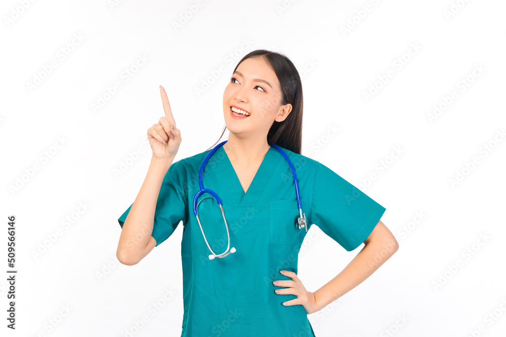 Portrait of professional confident young asian female smiling doctor in green scrubs showing presenting finger to empty space, doctor healthcare and doctors concept. Portrait of professional confident young asian female smiling doctor in green scrubs showing presenting finger to empty space, doctor healthcare and doctors concept.