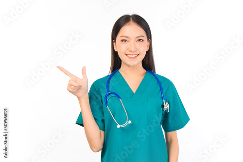Portrait of professional confident young asian female smiling doctor in green scrubs showing presenting finger to empty space  doctor healthcare and doctors concept.