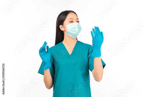 portrait asian female doctor in scrubs standing fingers protection flu cold facial with mask wearing surgical gloves