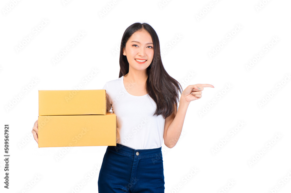 Happy cute asian woman smiling and holding package online marketing and delivery Start a small business at home on white background, Delivery shipping service concept. Happy cute asian woman smiling and holding package online marketing and delivery Start a small business at home on white background, Delivery shipping service concept.