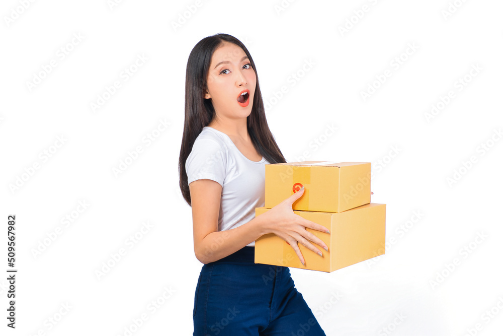 Happy cute asian woman smiling and holding package online marketing and delivery Start a small business at home on white background, Delivery shipping service concept. Happy cute asian woman smiling and holding package online marketing and delivery Start a small business at home on white background, Delivery shipping service concept.