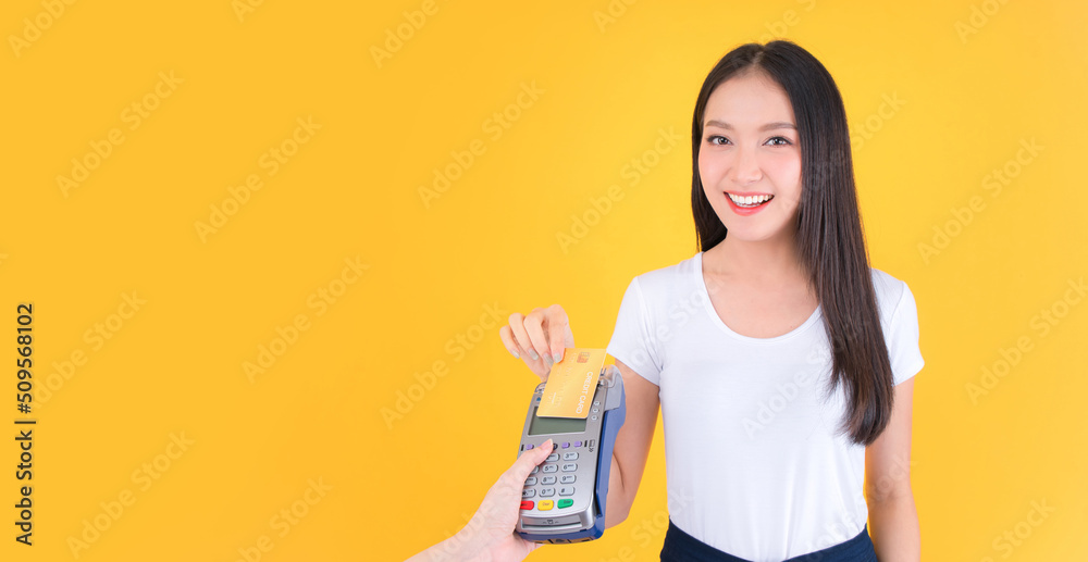 Moment of payment, payment with a credit card through terminal money yellow background,Mobile banking, online shopping Payment by card with the payment terminal. Moment of payment, payment with a credit card through terminal money yellow background,Mobile banking, online shopping Payment by card with the payment terminal.