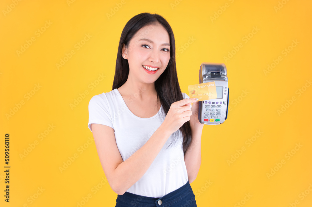 Moment of payment, payment with a credit card through terminal money yellow background,Mobile banking, online shopping Payment by card with the payment terminal. Moment of payment, payment with a credit card through terminal money yellow background,Mobile banking, online shopping Payment by card with the payment terminal.