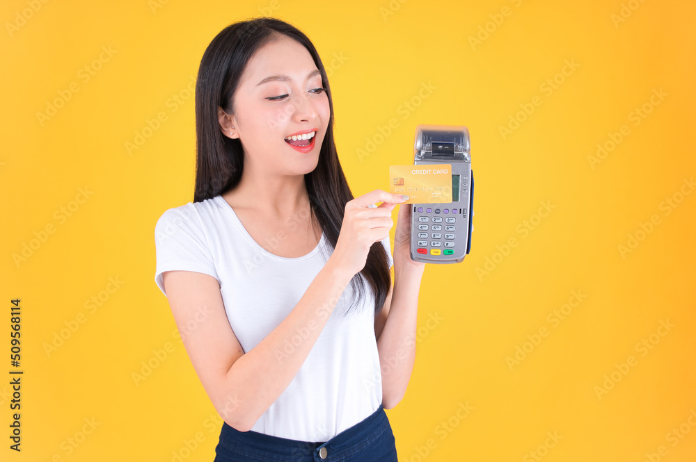 Moment of payment, payment with a credit card through terminal money yellow background,Mobile banking, online shopping Payment by card with the payment terminal. Moment of payment, payment with a credit card through terminal money yellow background,Mobile banking, online shopping Payment by card with the payment terminal.