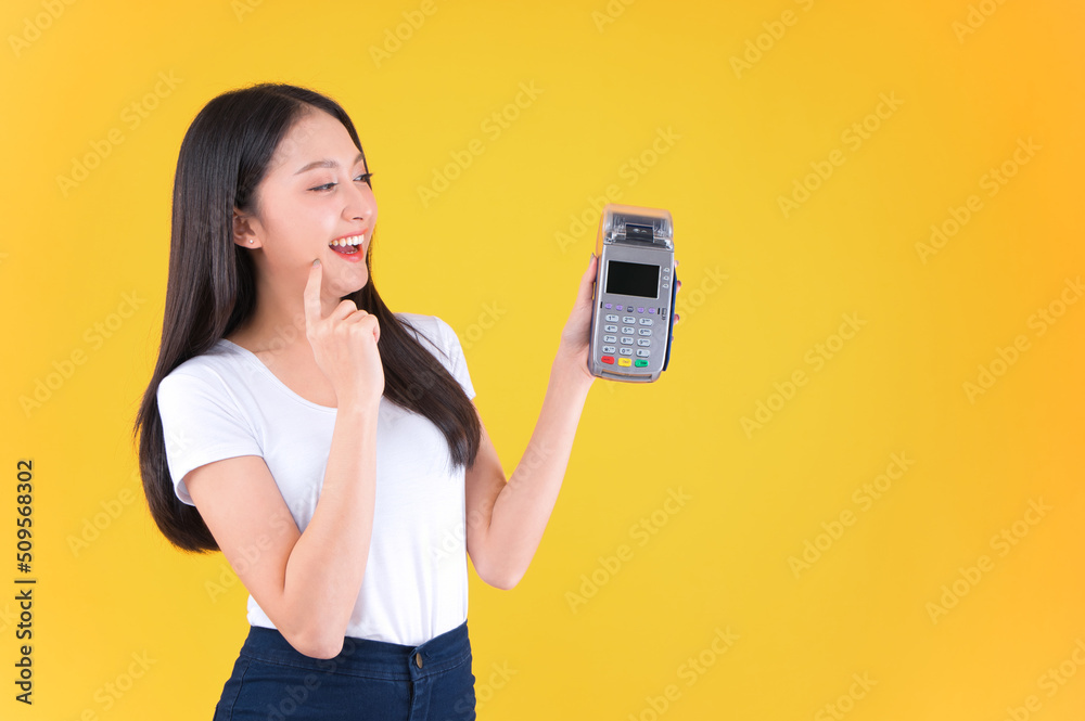 Moment of payment, payment with a credit card through terminal money yellow background,Mobile banking, online shopping money and financial concepts. Moment of payment, payment with a credit card through terminal money yellow background,Mobile banking, online shopping money and financial concepts.