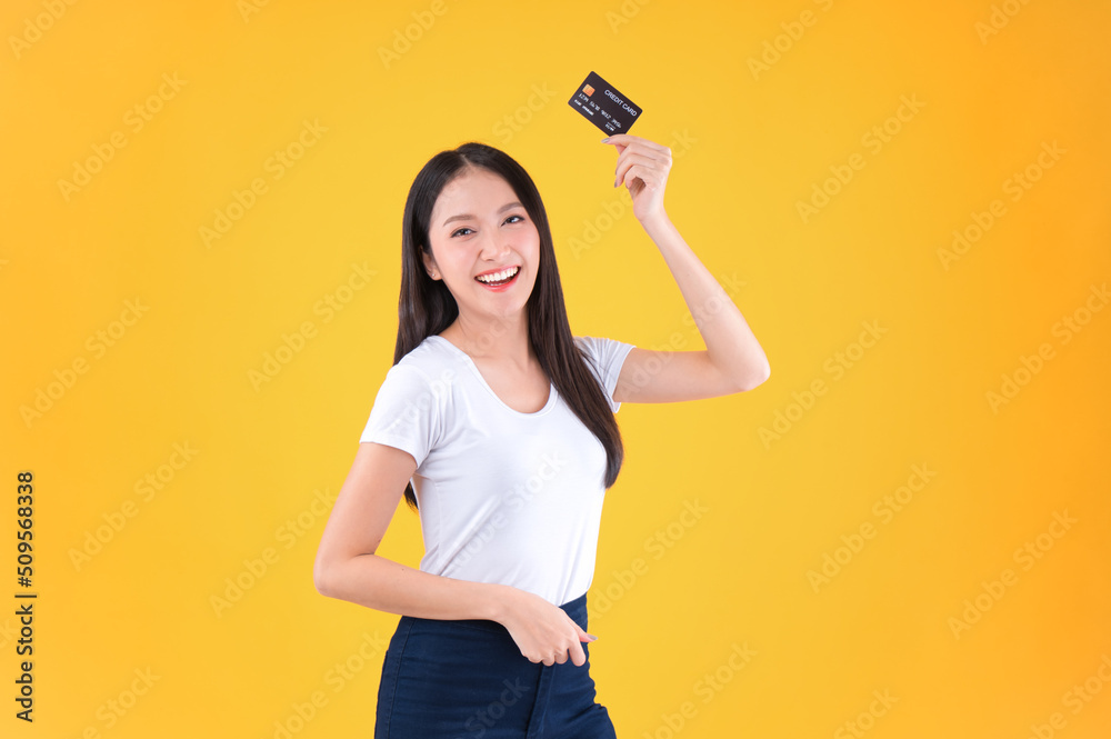 Photo happy positive pretty asian woman smile showing, presenting credit card for payment or paying online business payment credit card for confident money and financial concepts yellow background. Photo happy positive pretty asian woman smile showing, presenting credit card for payment or paying online business payment credit card for confident money and financial concepts yellow background.
