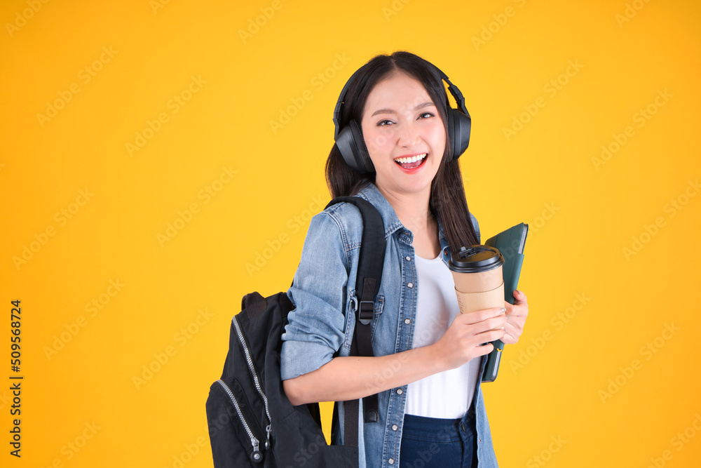 Portrait Cheerful young asian female student with backpack holding books education back to school and lifestyle concept yellow background. Portrait Cheerful young asian female student with backpack holding books education back to school and lifestyle concept yellow background.