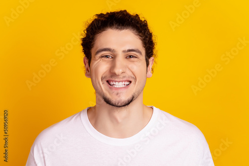 Photo of young cheerful guy good mood toothy smile veneers ceramic clinic isolated over yellow color background