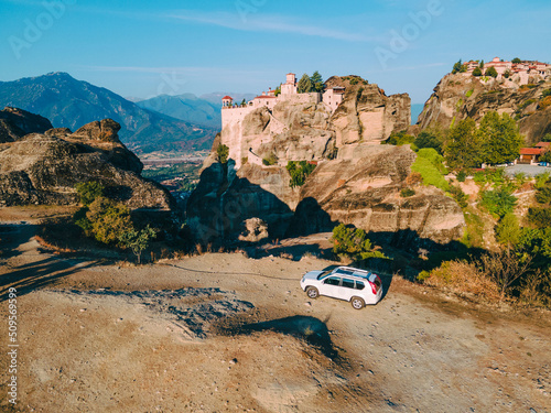 suv car road trip concept meteora monastery on background