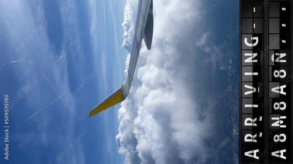 view of the sky from an airplane and a display board with arriving in Caracas, vertical video in 9-16