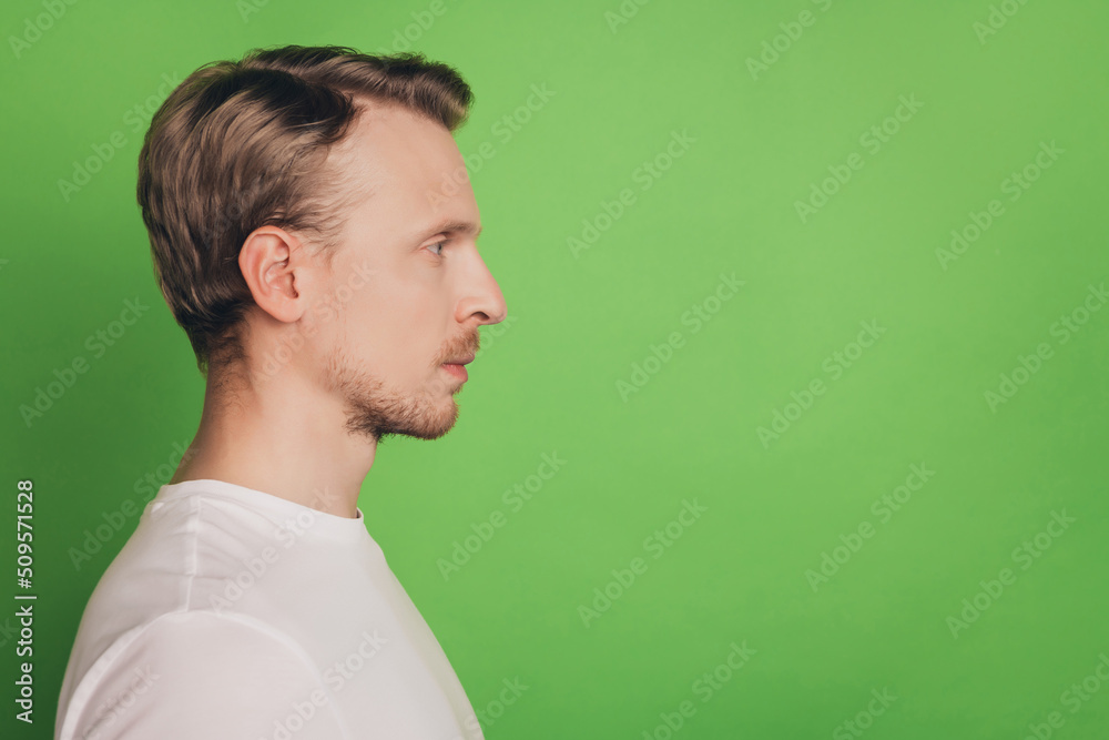 Profile view photo of successful beautiful smart man look empty space isolated on green color background Profile view photo of successful beautiful smart man look empty space isolated on green color background