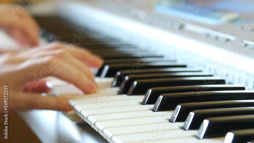 A woman's hand plays a fast melody on a synthesizer, jazz performance on the piano, playing on a synthesizer