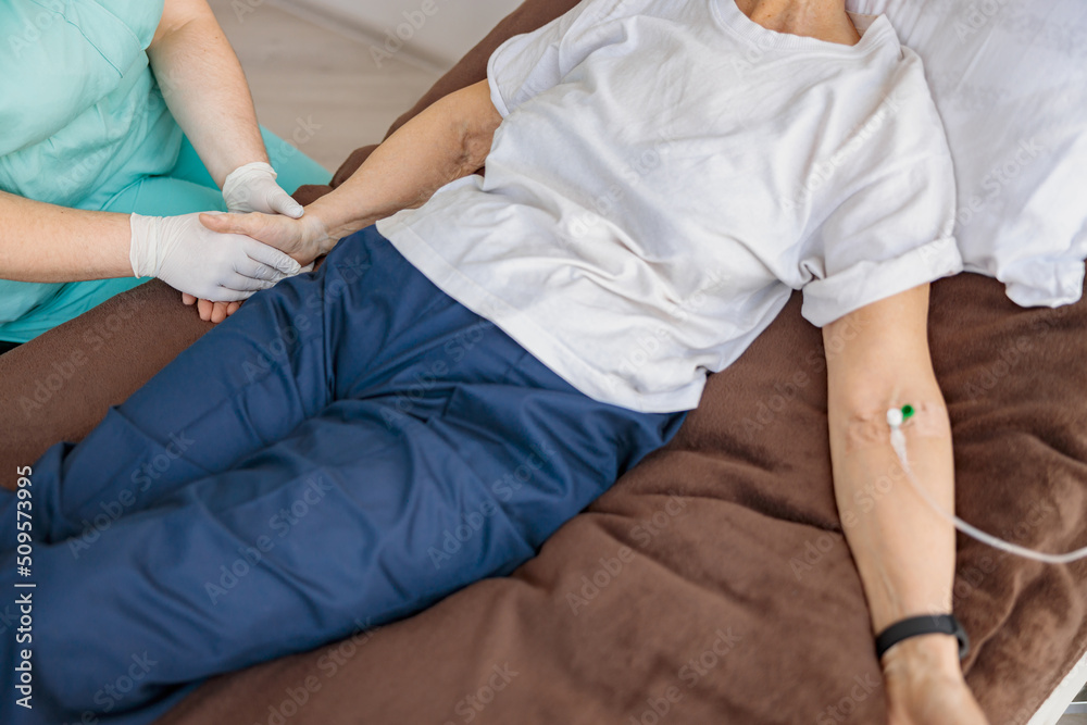 Professional Nurse controls drip of her patient in modern medicine clinic. High quality photo Professional Nurse controls drip of her patient in modern medicine clinic. High quality photo