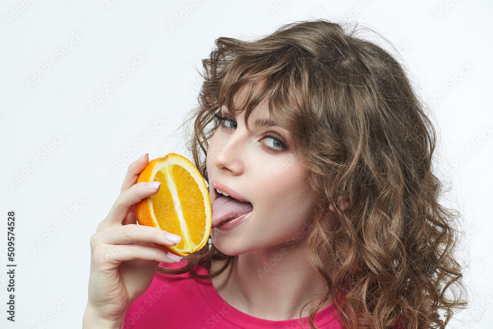 attractive girl holding an orange in her hands photoshoot in the studio on a white background attractive girl holding an orange in her hands photoshoot in the studio on a white background