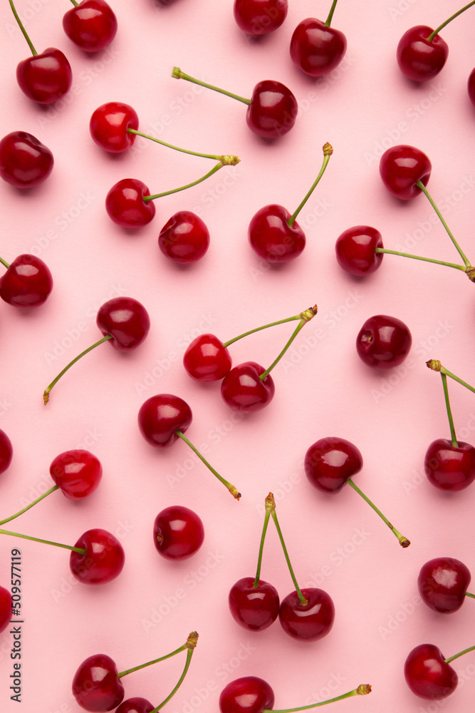 Sweet cherry on pink background. Top view. Flat lay.