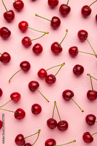 Sweet cherry on pink background. Top view. Flat lay.