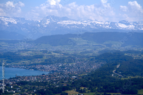 Aerial view of Lake Zürich and Canton Zürich with the Swiss Alps in the background seen from local mountain Uetliberg on a sunny spring day. Photo taken May 18th, 2022, Zurich, Switzerland.