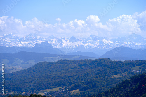 Aerial view of landscape at Canton Zürich with the Swiss Alps in the background seen from local mountain Uetliberg on a sunny spring day. Photo taken May 18th, 2022, Zurich, Switzerland.