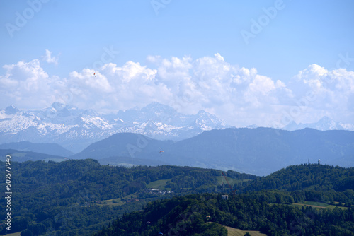 Aerial view of landscape at Canton Z  rich with the Swiss Alps in the background seen from local mountain Uetliberg on a sunny spring day. Photo taken May 18th  2022  Zurich  Switzerland.