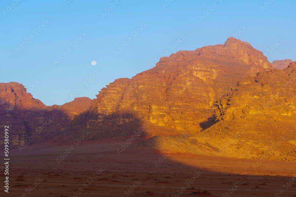 Cliffs and various rock formations, and the moon, Wadi Rum