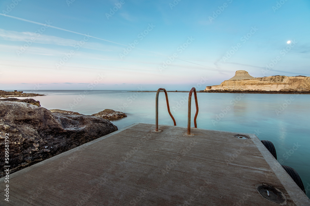 Obraz premium Typical stairs of the Island of Malta for easy access to the Mediterranean Sea, Gozo, Malta.