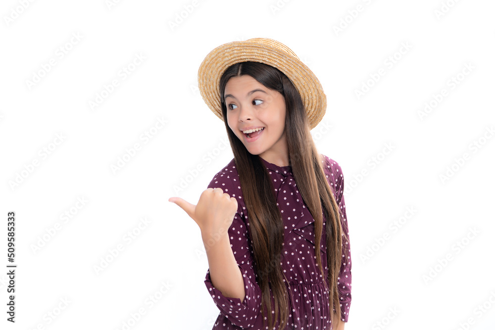 Look at advert. Teenager child points aside shows blank copy space for text promo idea presentation, poses against white isolated background. Portrait of happy smiling teenage child girl.