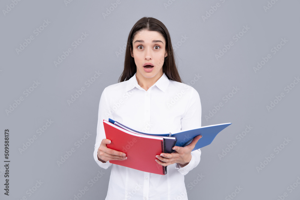 Charming student isolated on gray background. Woman high school student hold notebooks. Education in high school university college. Charming student isolated on gray background. Woman high school student hold notebooks. Education in high school university college.