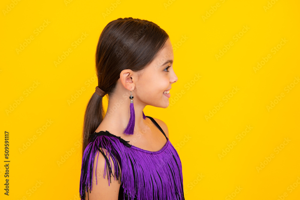 Close up profile portrait of caucasian teen girl. Head shot of cute teenager child on yellow isolated studio background. Close up profile portrait of caucasian teen girl. Head shot of cute teenager child on yellow isolated studio background.